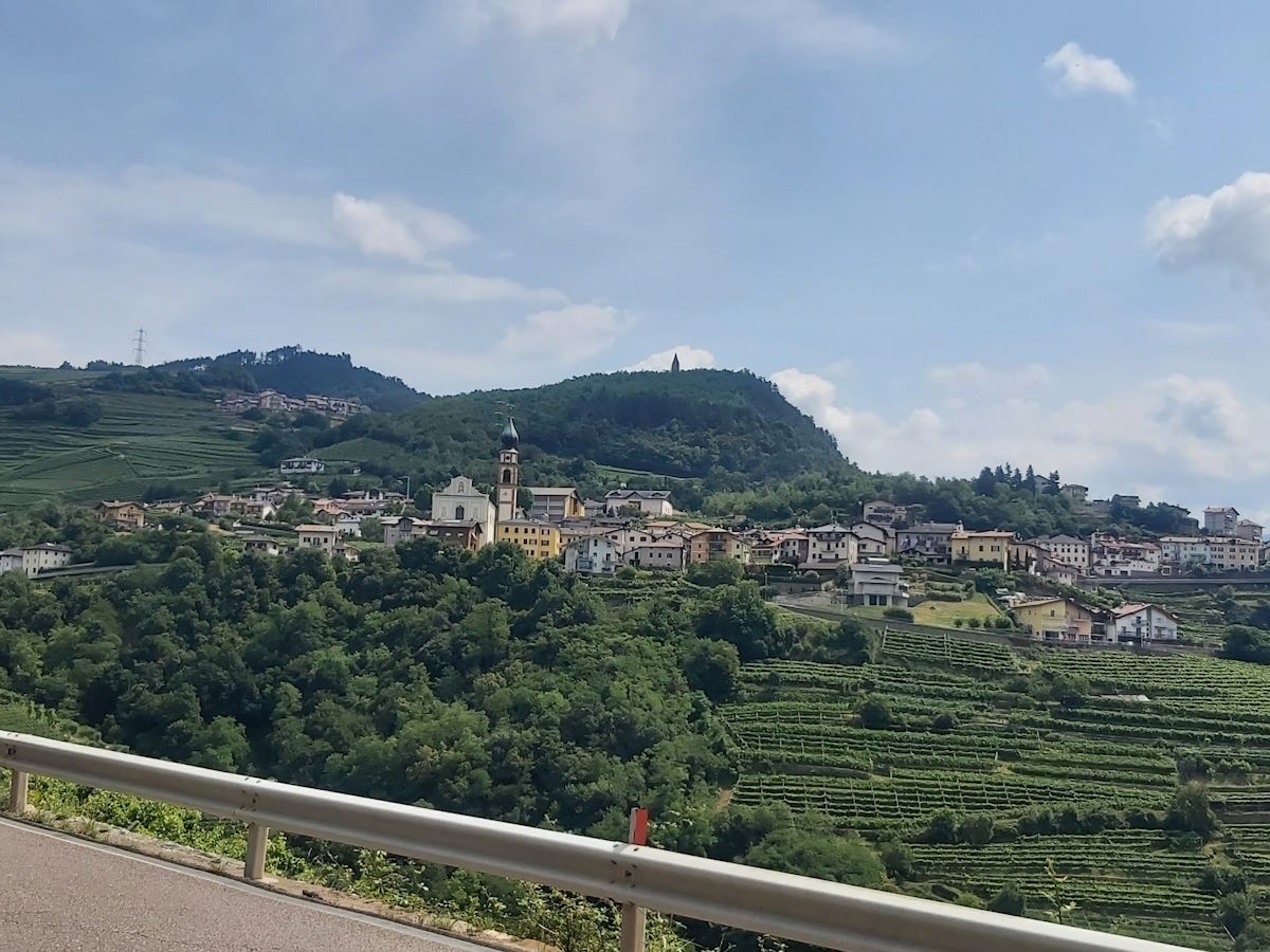 Italian vineyards hillside villages sweeping roads Alps motorcycle tour