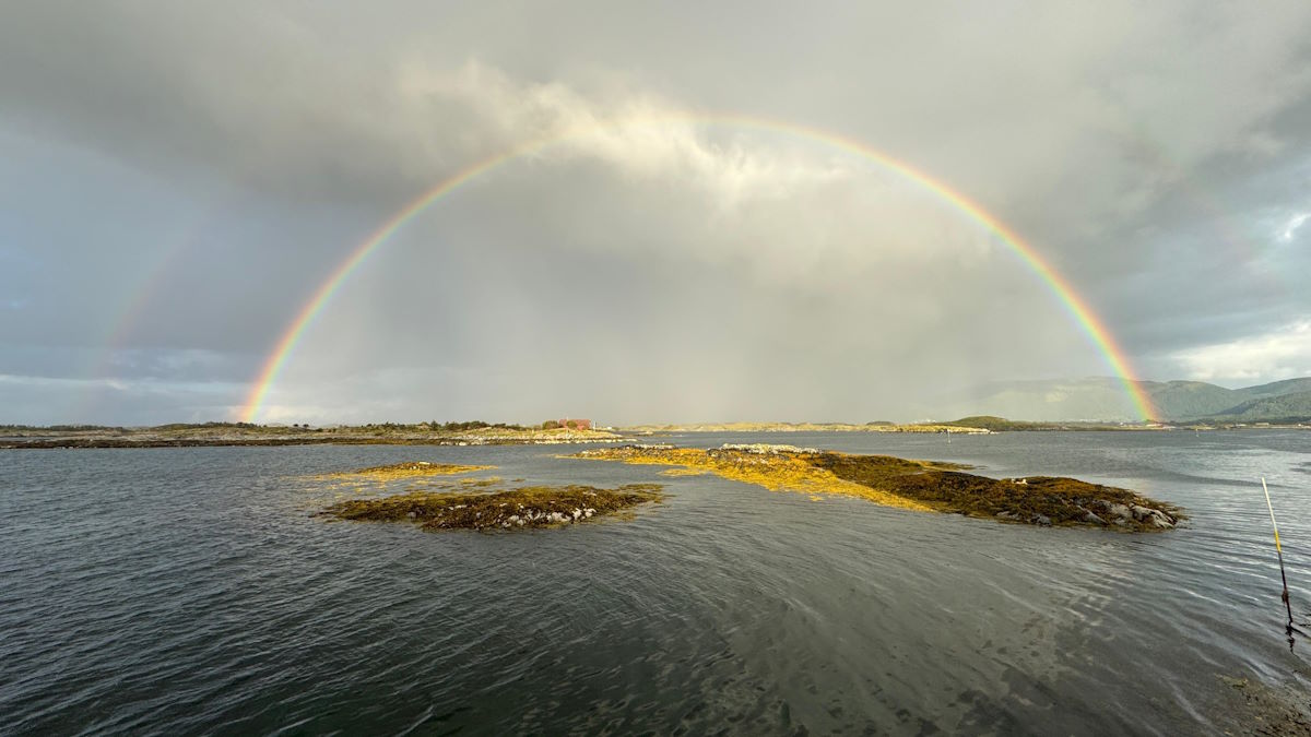 Rainbow over Håholmen Havstuer A historic fishing village on the private island of Håholmen Norway