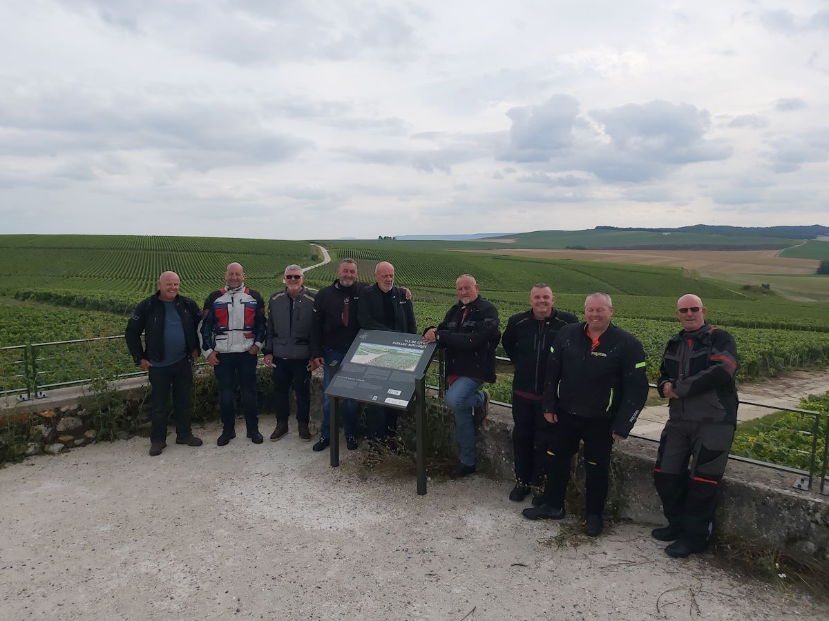 Columbus Motorcycle Tours group photo champagne vineyards viewpoint Reims region France day one Austrian Swiss Alps 2024