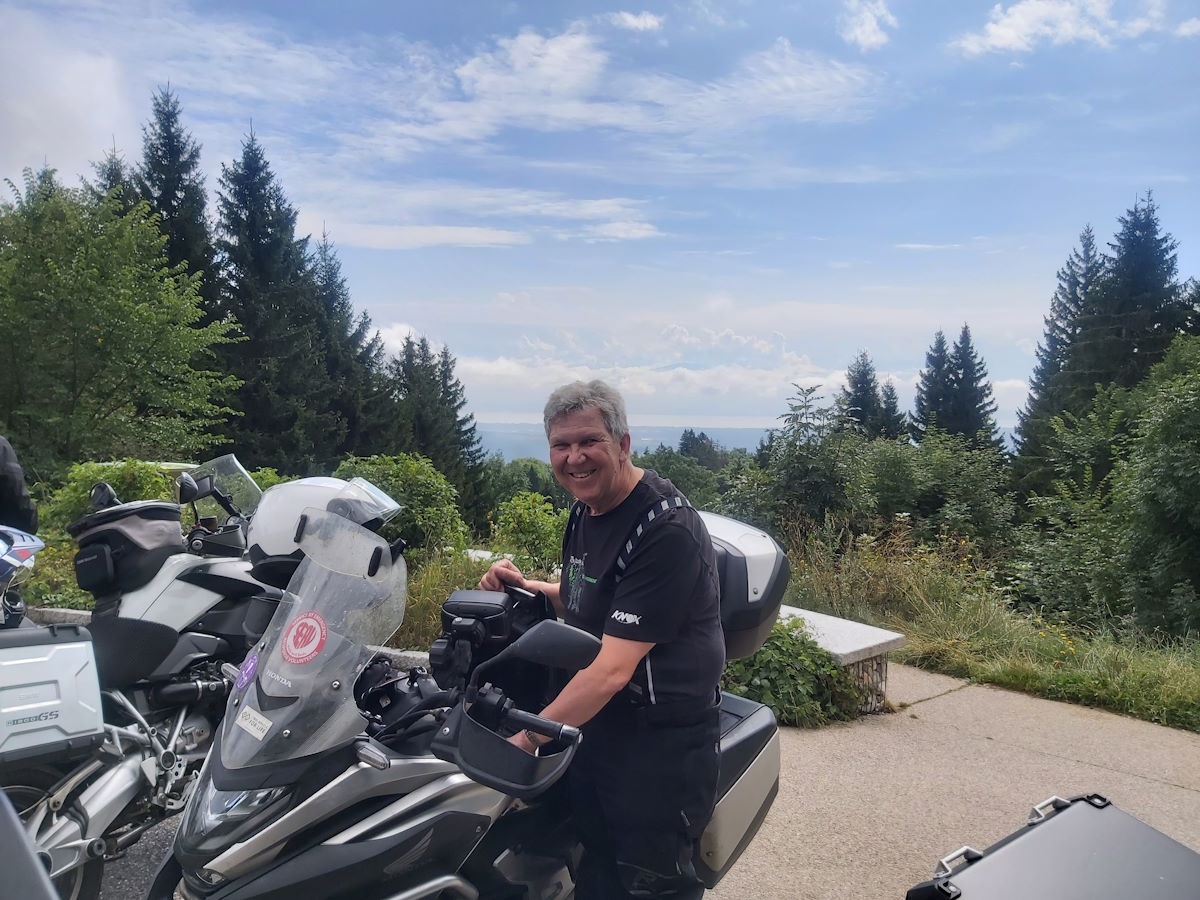 Tour rider Honda motorcycle scenic viewpoint Lake Geneva far background Jura region Route Napoleon 2024