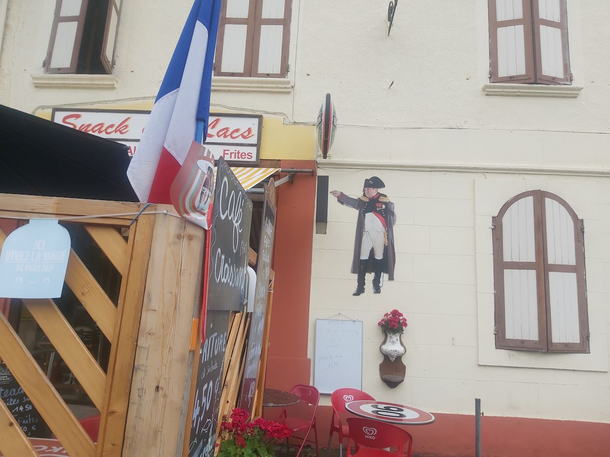 Historic Napoleon figure French cafe wall tricolor flag snack stop Route Napoleon tour France 2024