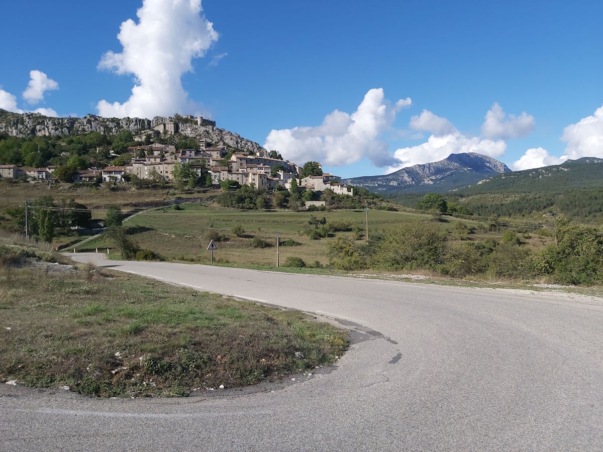 Scenic road sweeping curve hillside village limestone cliffs mountain scenery Route Napoleon September 2024n