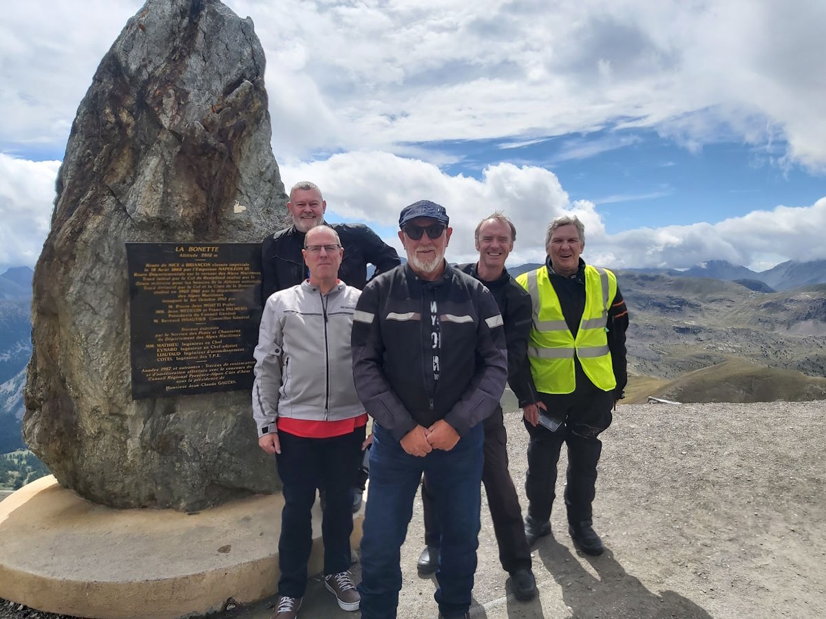 motorcycle riders top of col de bonette hairpin bends multiple passes Alpine scenery motorcycle tour