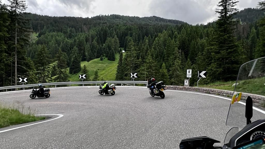 Columbus Motorcycle Tours group riding through a hairpin bend in the Dolomites