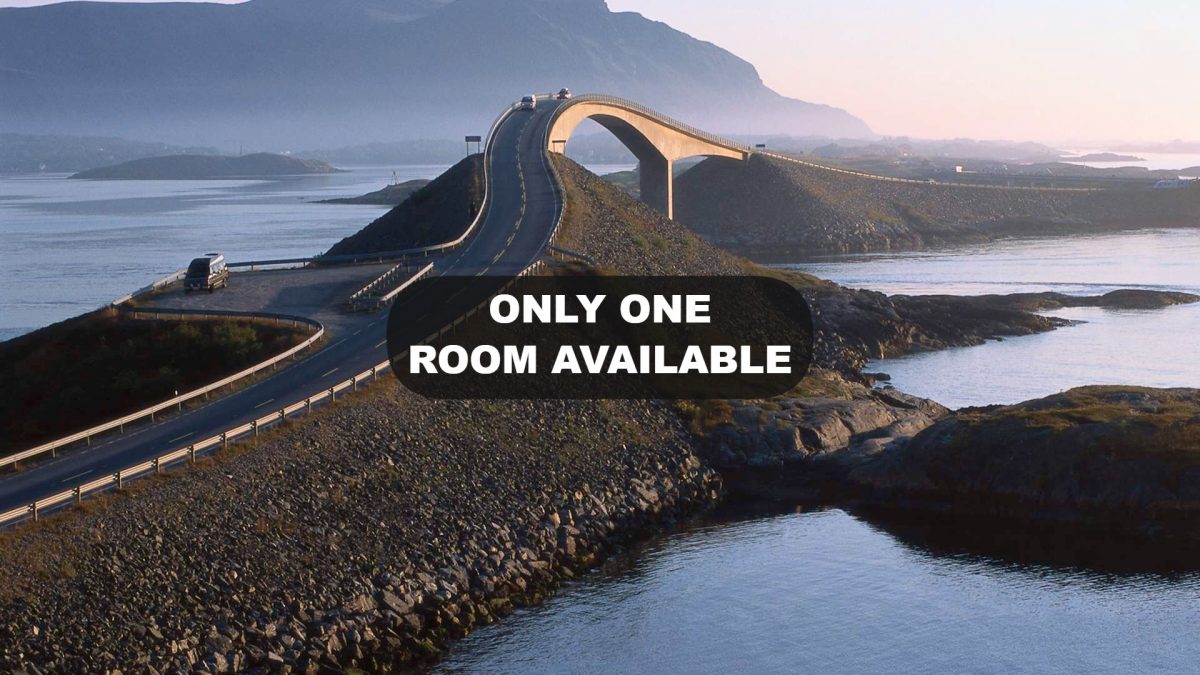 Motorcycle riding famous Atlantic Ocean Road Norway Storseisundet curved bridge connecting islands dramatic Norwegian coastal scenery guided tour
