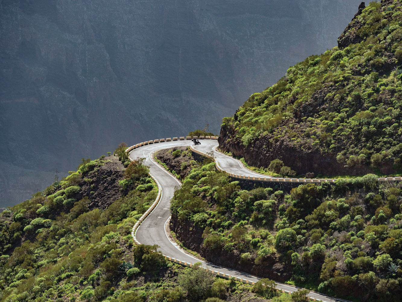 Motorcycle on dramatic switchback road Tenerife National Park Canary Islands guided motorcycle tour
